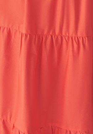 Korallivärvi kangas pehmea tekstuuriga, millel on kokku kogutud volang detail allääres. Disain on lihtne ja voolav.