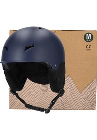 Blå matt skidhelm med ventilationsöppningar och mjuk inredningsvaddering, uppvisad med en brun papperslåda med geometrisk bergdesign.