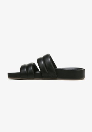 Schwarze Leder-Sandalen mit flachem Fußbett und drei verdrehten Riemen. Die Kanten sind abgerundet, was ein schlichtes Design ergibt.