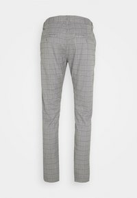 Pantaloni grigi a taglio aderente con motivo a quadri bianchi, dotati di passanti per cintura e tasche posteriori con bottoni.