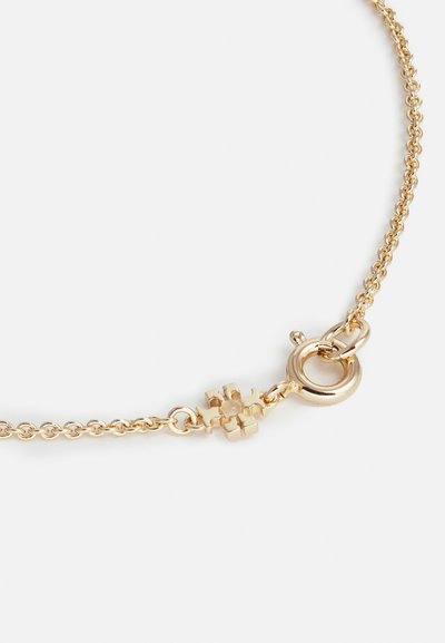 Guldhalsband med en fin länkdesign. Har en fjärrklämma och en dekorativ detalj nära klämman, slät yta.