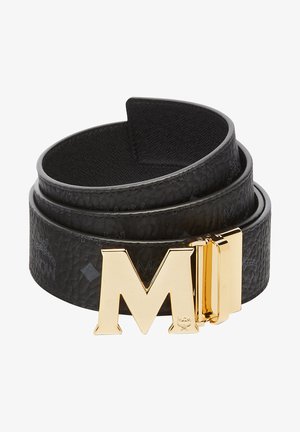 Black leather belt featuring a gold metal buckle with an "M" design. The belt has a textured finish and embossed logo details.