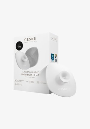 GESKE SmartAppGuided 4-in-1 white silicone facial brush with multi-surface suction mount, shown with box highlighting features and awards.