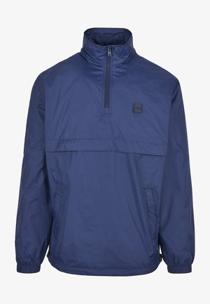 Marineblauer leichter Pullover-Jacke mit hohem Kragen, halbem Reißverschluss auf der Vorderseite, elastischen Bündchen und Seitentaschen. Glattes, wasserabweisendes Material.