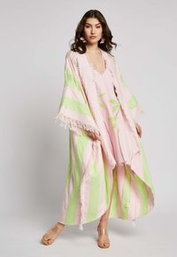 Pitkä, virtaava kimono vaaleanpunaisesta ja vihreästä raidallisesta kankaasta, jossa on fringesomisteet. Tässä on syvä V-pääntie ja vaaleanvihreää kukkakirjontaa.
