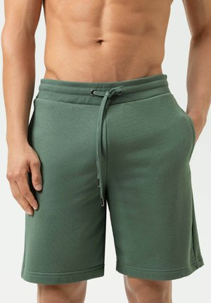 Groene short van een katoenmix met een elastische tailleband, trekkoordsluiting en zijzakken. Gladde structuur en een ontwerp tot op de knie.