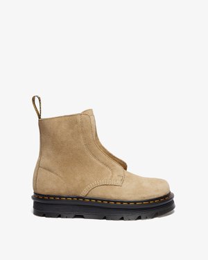 Tan suede ankle boot with a smooth texture, elastic side panels, pull tab, and black sole with yellow stitching and rugged tread.