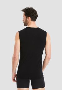 Black sleeveless tank top made of soft fabric, featuring a round neckline and a relaxed fit, with a smooth texture and clean edging.