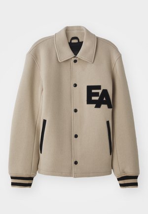 Chaqueta de mezcla de lana beige con un acabado texturizado, acentos negros, botones a presión, bolsillos laterales y un logotipo bordado "EA" en el pecho.