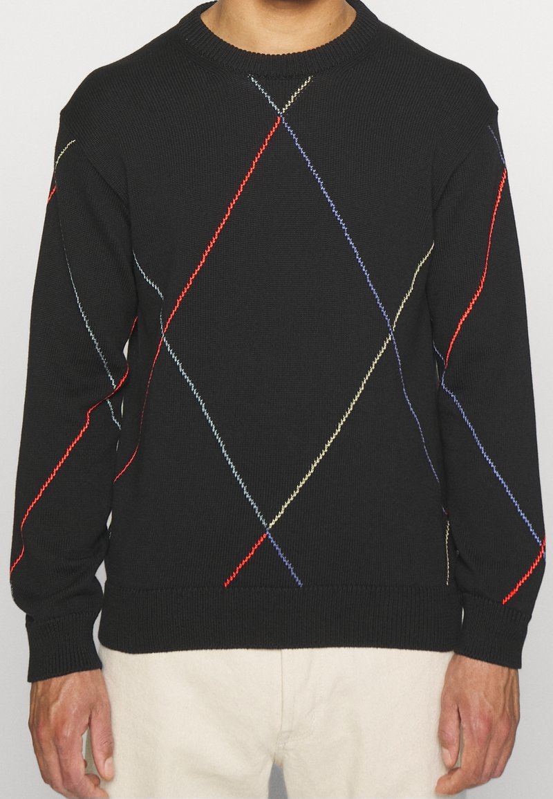 Černý svetr s vroubkovaným kulatým výstřihem. Obsahuje diamantové vícestínové prošívání v červené, modré a žluté barvě. Texturovaná tkanina.