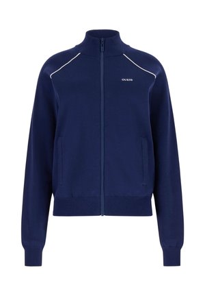 Marineblauwe ritsvest met hoge kraag, witte biezen op de schouders, voorzakken en een klein "GUESS" logo op de linkerborst.