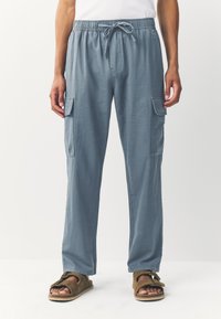 Light blue cargo pants with an elastic waistband and drawstring. Features side pockets and a straight leg design. Smooth, lightweight fabric.