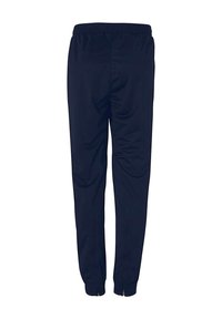 Marineblå træningsbukser med elastisk talje, stramme ben og lynlåsdetaljer ved anklerne; glat, let stof.