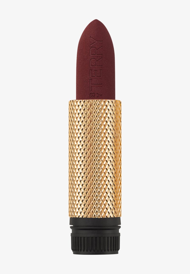 Rouge à lèvres dans un étui doré à motif de diamants avec une base noire ; riche couleur bordeaux avec le nom de la marque embouti au bout.