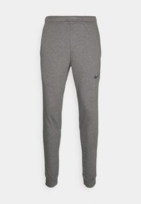 Graue Nike-Sweatpants aus weichem Stoff, mit schmal zulaufendem Schnitt, elastischem Bund und kleinem schwarzen Logo auf dem linken Oberschenkel.