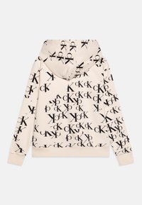 Mikina s kapucí ve světle béžové barvě z bavlněné směsi, pokrytá celoplošným černým potiskem loga. Obsahuje žebrované manžety a lem.