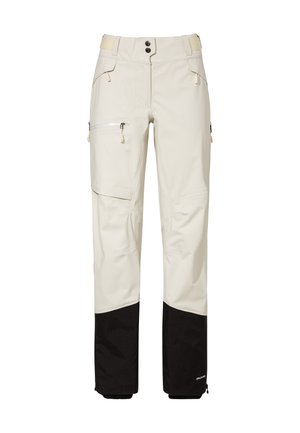 Lichtbeige outdoorbroek met zwart verstevigd materiaal op de onderbenen, ritssluitingen in de zakken en verstelbare Velcro taillebanden.