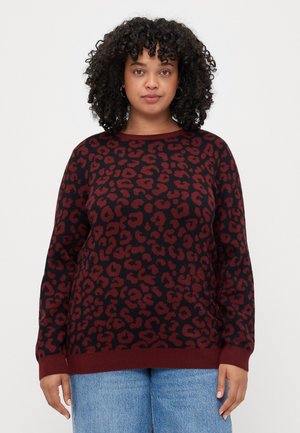 Pulover cu imprimeu de leopard maroniu și negru, cu mâneci lungi și gât rotund. Marginile și mansetele ribbate. Textură moale tricotată.