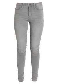 Graue Denim-Jeans mit schmaler Passform, Fünf-Taschen-Design und Reißverschluss. Mit dezentem Verblassen und Nähakzenten entlang der Beine.