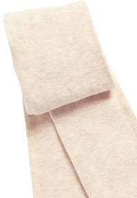 Collant beige a coste con una texture liscia, caratterizzati da una parte superiore piegata e uno spessore uniforme su tutta la gamba.