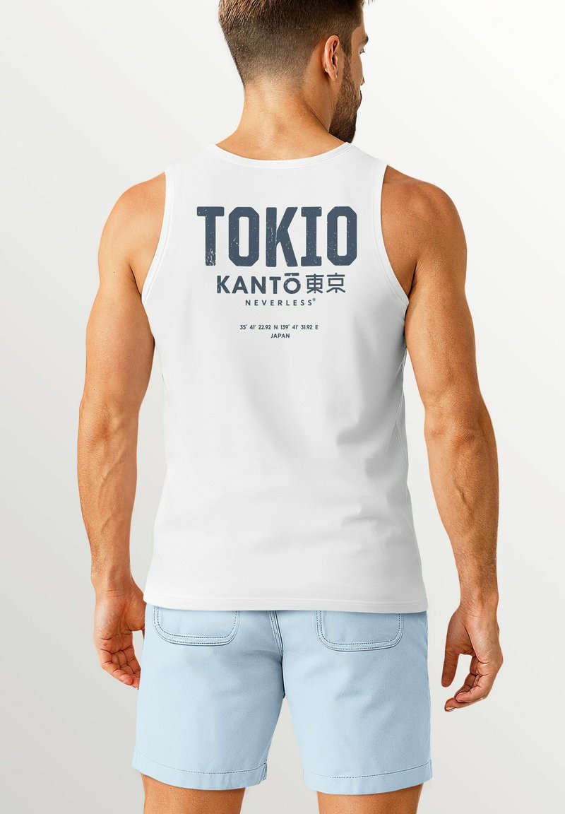 White cotton tank top featuring "TOKIO KANTO" in bold dark print on the back, with coordinates and "JAPAN" text below. Pair with light blue shorts.