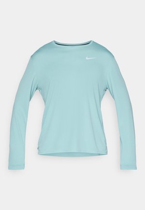 Long-sleeve light blue athletic shirt made of smooth fabric, featuring a crew neckline and a small white Nike logo on the upper left.