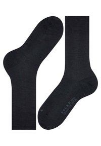 Calzini neri in cotone con una texture liscia. Presentano aree rinforzate sulla punta e sul tallone, e un logo discreto sulla suola.