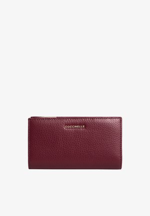 Portafoglio in pelle bordeaux, finitura testurizzata, forma rettangolare, logo dorato sul davanti, chiusura con zip nella parte superiore, scomparti per più carte all'interno.