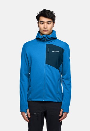 Veste zippée bleue avec capuche, dotée d'un panneau de poitrine bleu foncé, en tissu extensible, au design ajusté et avec des poches latérales.