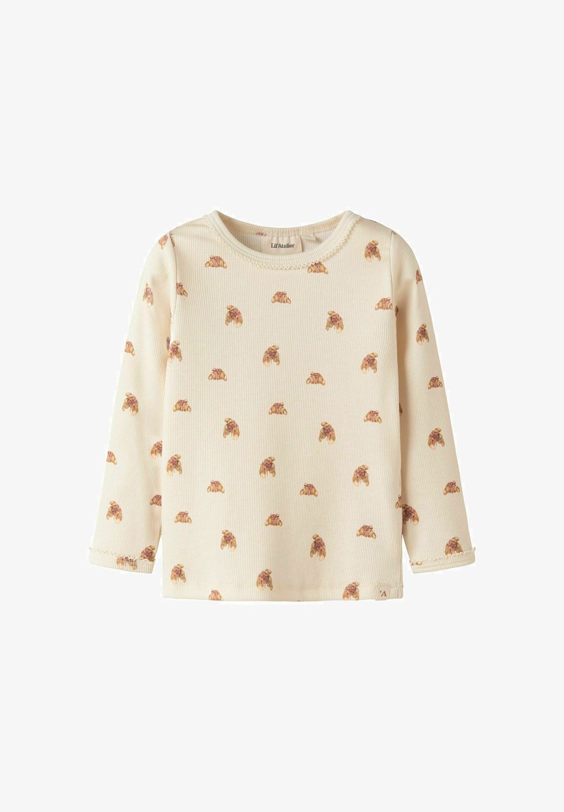 Cremfarbendes Langarmshirt mit geripptem Muster und einem wiederholten Croissant-Motiv. Runde Ausschnittform und genähte Ärmelabschlüsse.