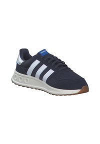 Navy blue athletic shoe with white stripes, suede and mesh materials, a rubber sole, and a silver heel accent. Includes a blue logo tag.