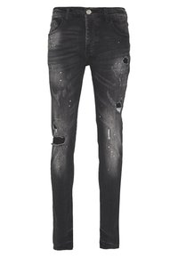 Černé džíny z denimu s úzkým střihem, zdobené opotřebovanými detaily včetně roztržení a skvrn od barvy. Design s pěti kapsami a zapínáním na knoflíky.