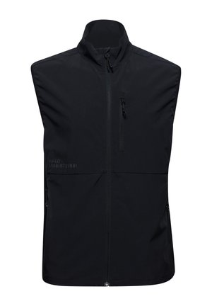 Zwarte mouwloze vest van lichtgewicht stof. Beschikt over een hoge kraag, een ritssluiting aan de voorkant en twee zijzakken met ritsen.