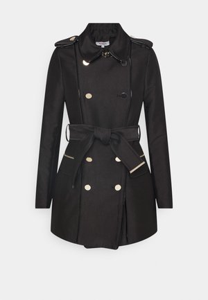 Trench-coat noir à double boutonnage avec boutons dorés, épaulettes, taille ceinturée, poches latérales zippées et large col.
