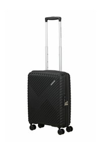 Valise rigide noire avec motif texturé diagonal, quatre roues pivotantes, poignée rétractable et serrure à combinaison latérale.