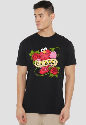 Black cotton t-shirt featuring a bright red Elmo graphic with green accents and roses, round neckline, and short sleeves.