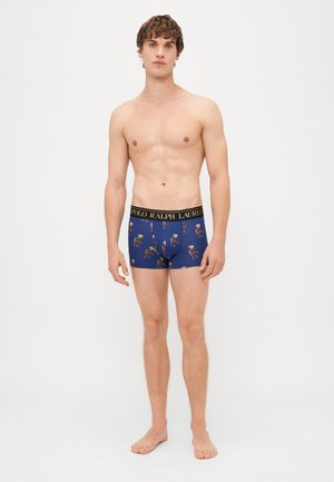 Tamsiai mėlynos boxer tipo trumpikės su dekoratyviniu kaukolės raštu, turinčios juodą juosmenį su "POLO RALPH LAUREN" auksinėmis raidėmis.