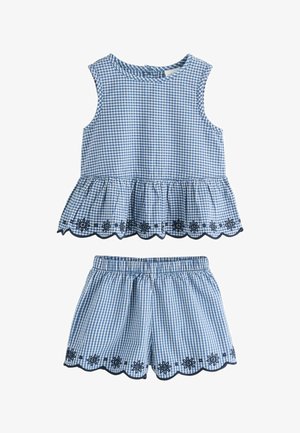 Top fără mâneci în carouri alb-albastre cu tiv cu volănașe și pantaloni scurți asortați cu talie elastică, ambele cu broderie florală neagră.