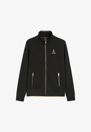 Czarna kurtka rozpinana na zamek z stójką, dwoma przednimi kieszeniami na zamek i małym złotym logo Dakar na lewej piersi.