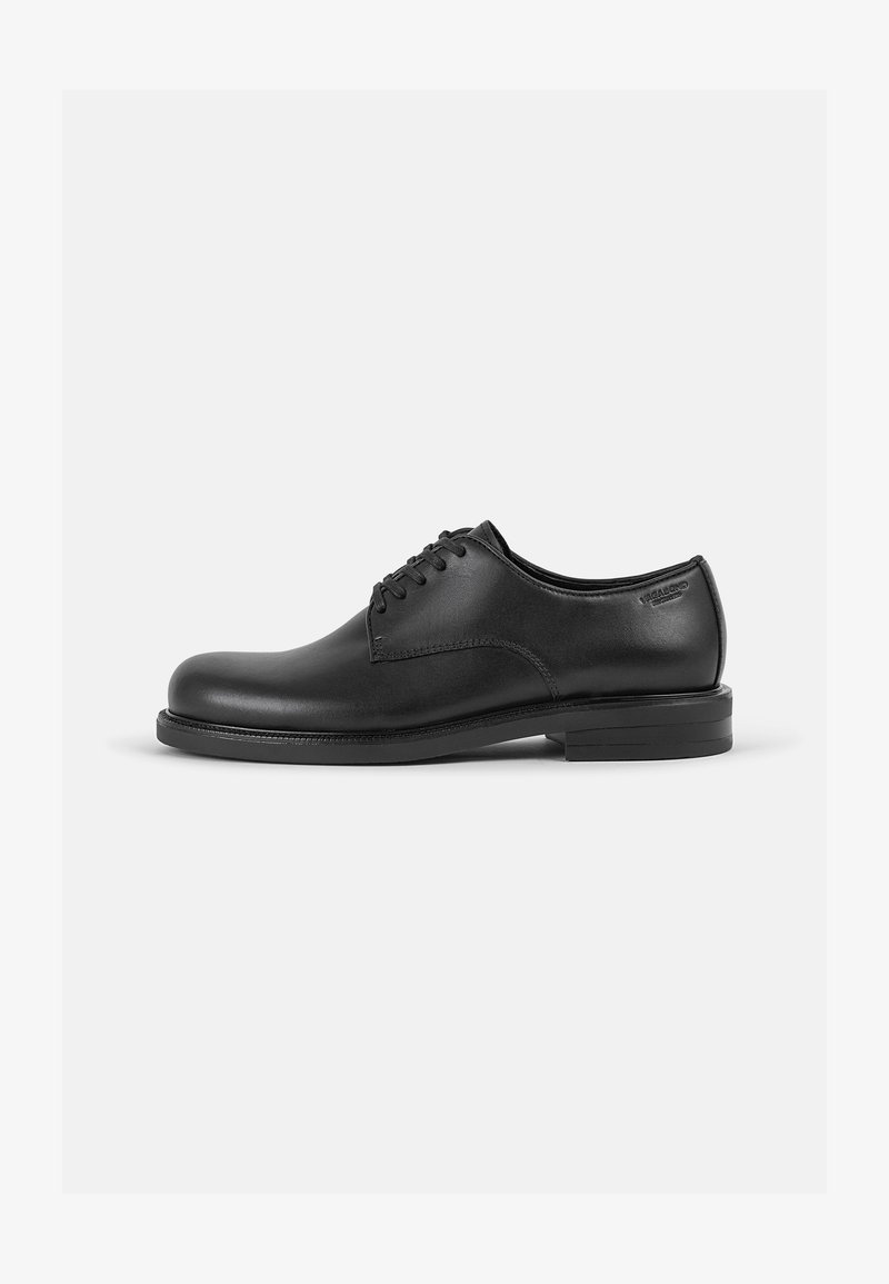 Chaussures en cuir noir à lacets avec un bout rond, texture lisse, design minimaliste et semelle noire solide. Branding subtil sur le côté.