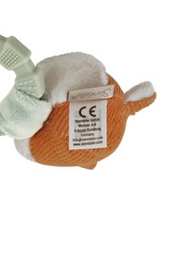 Soft plush toy in orange with white accents, featuring a smooth texture and rounded shape. Includes a green attachment strap and care label.