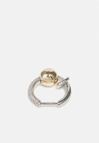 Gold and silver ring earring featuring a smooth spherical element and a textured band with small stones, circular shape.