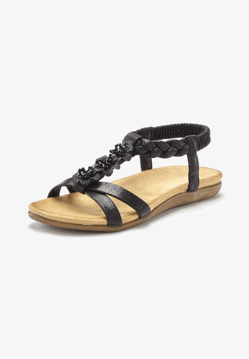 Schwarze Sandale mit geflochtenem Riemendesign und Blumenakzent. Verfügt über eine gepolsterte, braune Innensohle und einen elastischen hinteren Riemen für zusätzlichen Komfort.