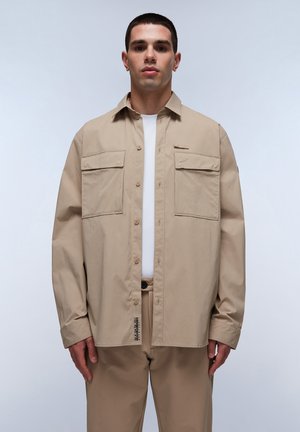 Beige cotton shirt with a relaxed fit, two front pockets, and a slight sheen. Features a fold-down collar and button closures.
