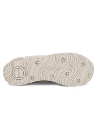 Semelle de chaussure gris clair avec un motif en vagues, dotée d'éléments de traction circulaires et d'un logo central. Surface texturée avec une finition mouchetée.