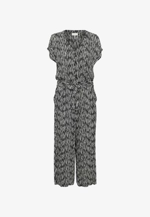 Melnā un baltā rakstātais kombinezons ar īsām piedurknēm, V veida kakla izgriezumu un jostu viduklī. Audums ir ar vertikālām svītrām un brīvu piegriezumu.