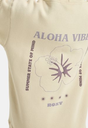 Felpa beige con colletto a coste. Presenta grafiche floreali viola e testi che includono "ALOHA VIBES" e "STATE OF MIND ESTIVA."