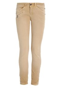 Jeans en denim beige ajustés avec une poche zippée, une fermeture à bouton et des coutures décoratives sur la poche avant. Tissu doux, riche en coton.