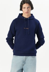 Navy blue hoodie made from cotton, featuring a front kangaroo pocket, adjustable drawstrings, and embroidered logo on the chest.