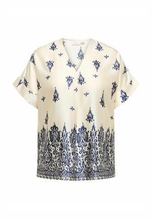 Cream blouse with navy blue damask pattern, short sleeves, and V-neck. Smooth fabric with intricate detailing at the hemline.